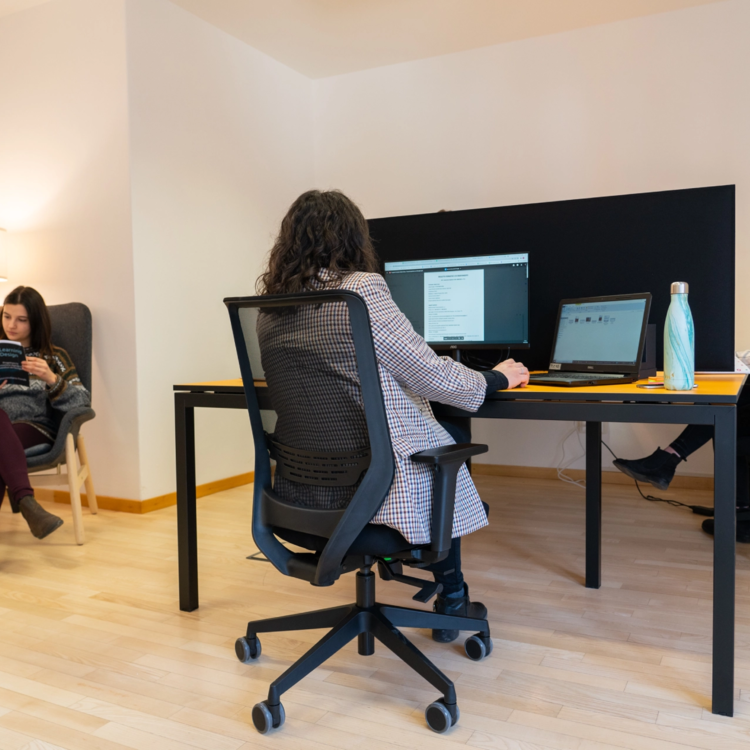 Varie donne sedute davanti ad una scrivania in smart working