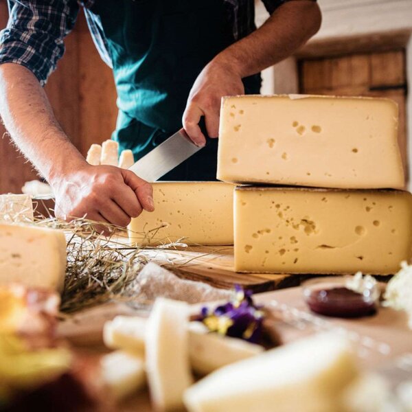 Uomo taglia i formaggi trentini